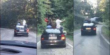 Mai mulţi tineri, dintre care unul pare a fi copil, filmaţi pe Transfăgărăşan pe capota maşinii