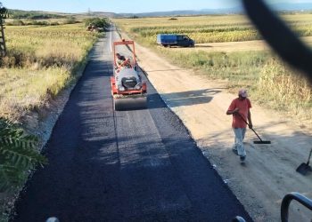 Asfalt proaspăt, în mijlocul câmpului. Imagine surprinsă în Ulmeni, Maramureș
